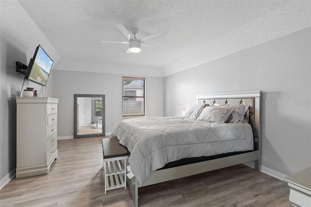 901 Vicksburg St, Deltona, FL 32725 - bedroom with a textured ceiling, light wood finished floors, baseboards, and a ceiling fan
