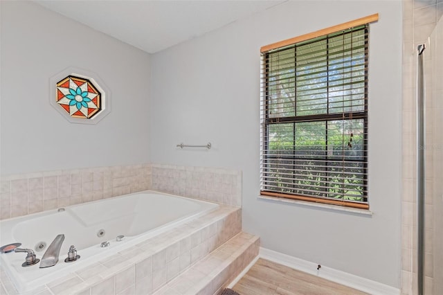 901 Vicksburg St, Deltona, FL 32725 - full bath with a jetted tub, baseboards, and wood finished floors