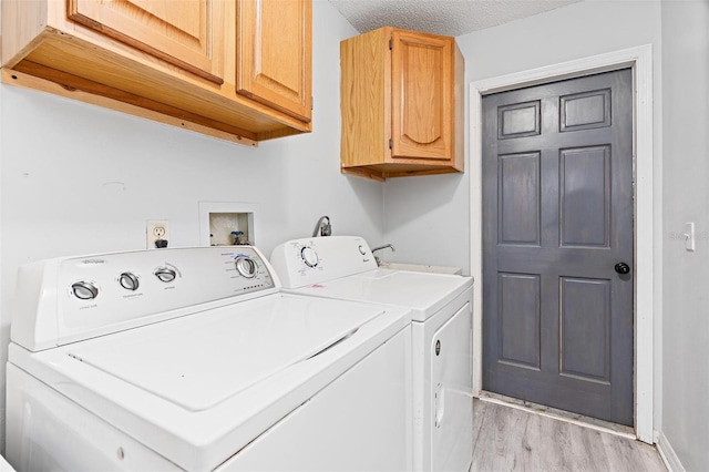 901 Vicksburg St, Deltona, FL 32725 - laundry room with washing machine and dryer, cabinet space, light wood-style floors, and baseboards