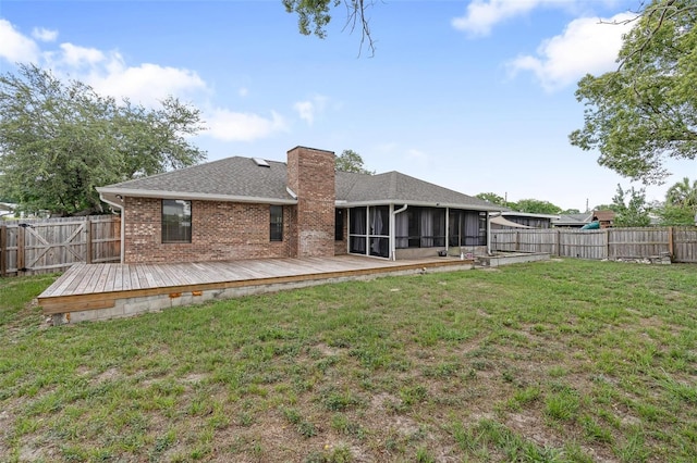 901 Vicksburg St, Deltona, FL 32725 - rear view of house featuring a sunroom, a wooden deck, brick siding, a chimney, and roof with shingles