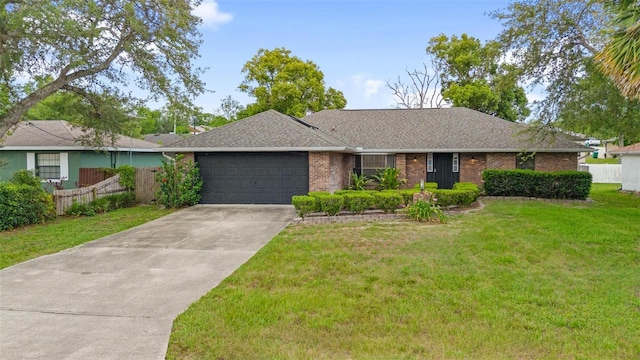 901 Vicksburg St, Deltona, FL 32725 - ranch-style home featuring a garage, driveway, brick siding, and roof with shingles