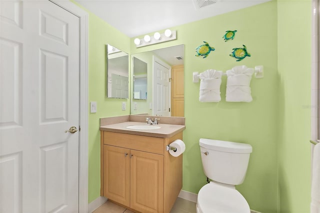 3315 S Atlantic Ave Unit 1406, Daytona Beach Shores, FL 32118 - bathroom featuring vanity, toilet, baseboards, and tile patterned floors