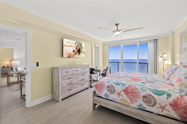3315 S Atlantic Ave Unit 1406, Daytona Beach Shores, FL 32118 - bedroom with a water view, access to outside, light wood-style flooring, crown molding, and baseboards