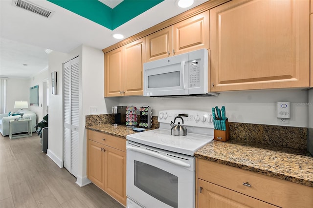 3315 S Atlantic Ave Unit 1406, Daytona Beach Shores, FL 32118 - kitchen featuring white appliances, light brown cabinets, light stone counters, open floor plan, and recessed lighting