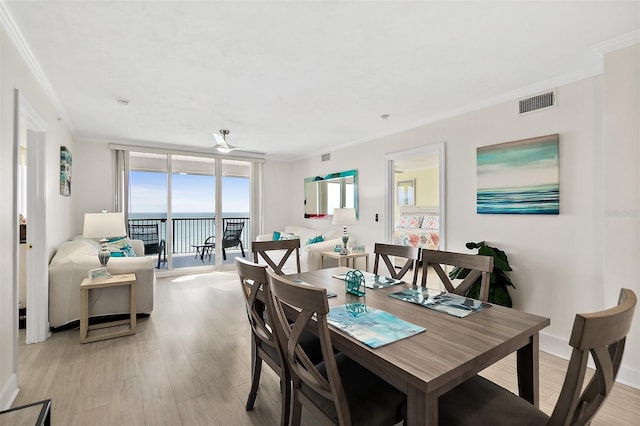 3315 S Atlantic Ave Unit 1406, Daytona Beach Shores, FL 32118 - dining area featuring crown molding and light wood finished floors
