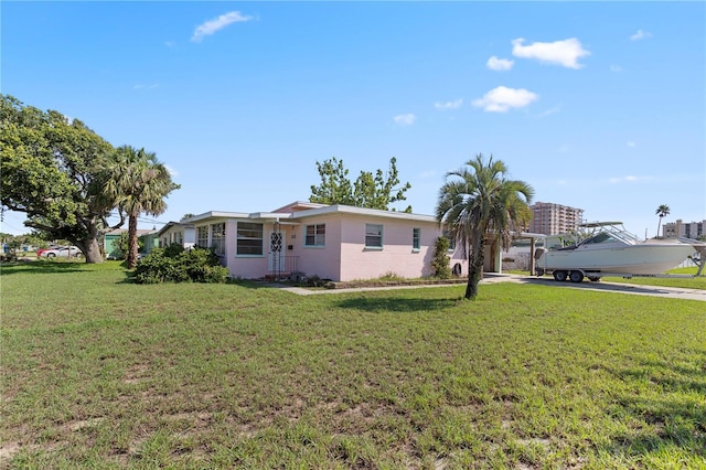 3267 S Peninsula Dr, Daytona Beach, FL 32118 - view of front of property with a front lawn and driveway