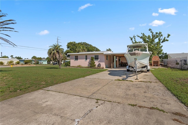 3267 S Peninsula Dr, Daytona Beach, FL 32118 - view of front of house featuring concrete driveway and an attached carport