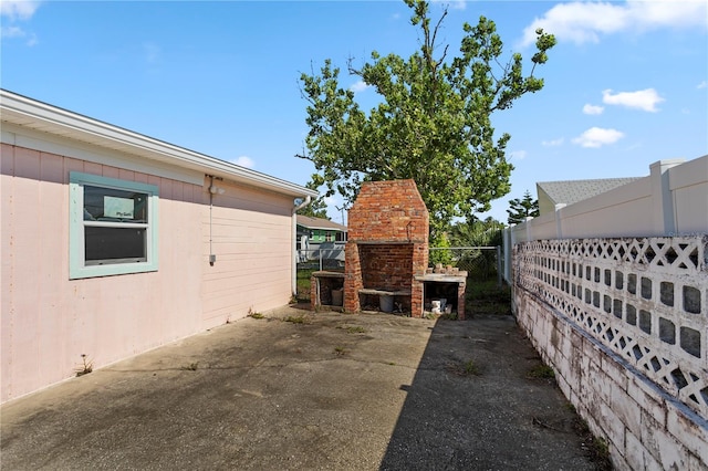 3267 S Peninsula Dr, Daytona Beach, FL 32118 - view of side of home with a fireplace and a patio