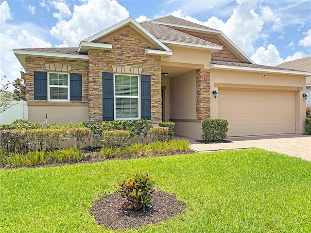 110 No Name Key Dr, Deland, FL 32720 - view of front facade featuring stone siding, stucco siding, an attached garage, driveway, and roof with shingles
