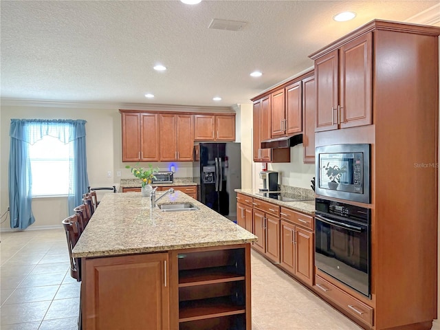 110 No Name Key Dr, Deland, FL 32720 - kitchen featuring black appliances, a sink, open shelves, an island with sink, and light stone countertops