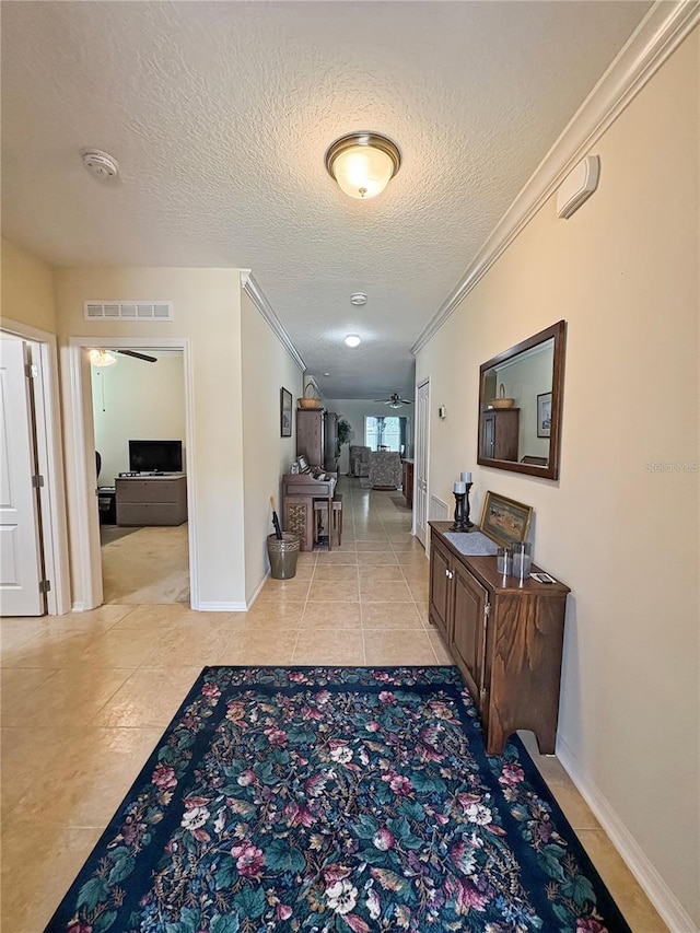 110 No Name Key Dr, Deland, FL 32720 - hallway with ornamental molding, tile patterned flooring, a textured ceiling, and baseboards