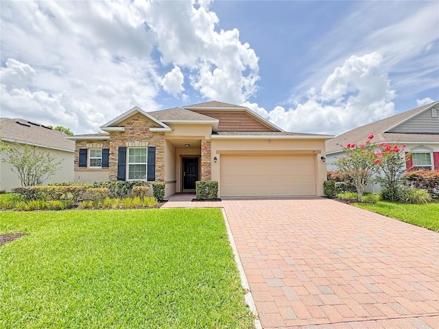 110 No Name Key Dr, Deland, FL 32720 - view of front of home featuring decorative driveway, a garage, a front lawn, stone siding, and stucco siding