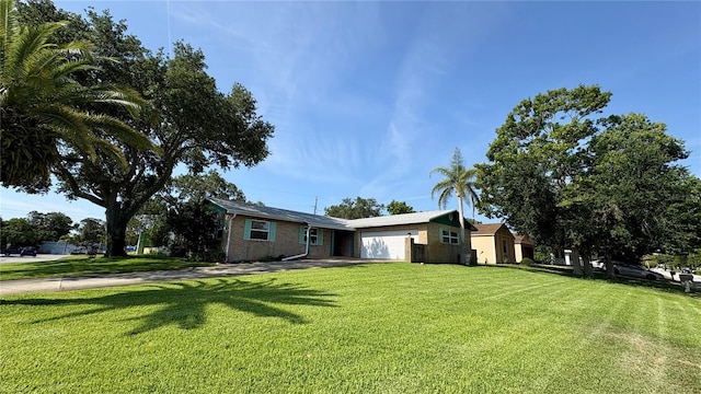 1301 Killian St, Daytona Beach, FL 32114 - ranch-style home with a front yard and a garage