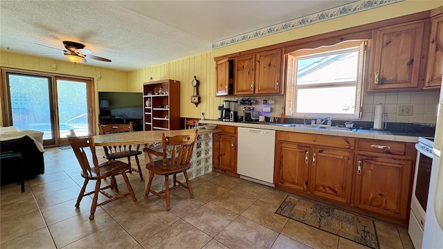 1301 Killian St, Daytona Beach, FL 32114 - kitchen with white appliances, a sink, brown cabinets, tile counters, and ceiling fan