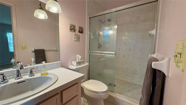 1301 Killian St, Daytona Beach, FL 32114 - full bath with a shower stall, toilet, vanity, and tile patterned flooring