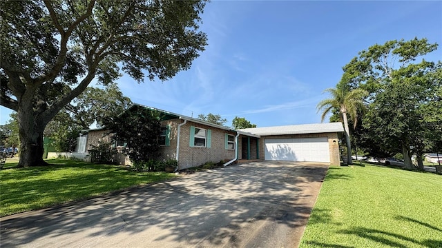 1301 Killian St, Daytona Beach, FL 32114 - view of front facade with brick siding, an attached garage, concrete driveway, and a front yard