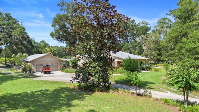 1056 Reynolds Rd, De Leon Springs, FL 32130 - view of green lawn featuring a detached garage