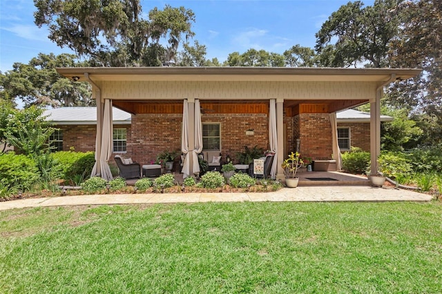 1056 Reynolds Rd, De Leon Springs, FL 32130 - rear view of property featuring a lawn and brick siding