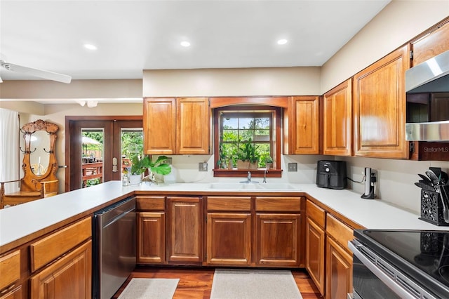 1056 Reynolds Rd, De Leon Springs, FL 32130 - kitchen with a sink, stainless steel appliances, light countertops, dark wood-style flooring, and recessed lighting