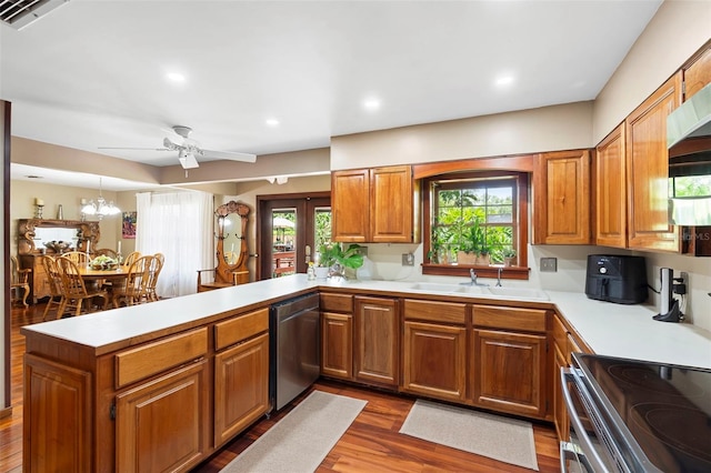 1056 Reynolds Rd, De Leon Springs, FL 32130 - kitchen featuring stainless steel dishwasher, a sink, a peninsula, brown cabinets, and recessed lighting