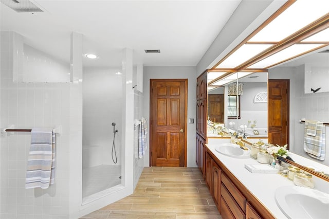 1056 Reynolds Rd, De Leon Springs, FL 32130 - bathroom featuring double vanity, walk in shower, wood finished floors, and recessed lighting