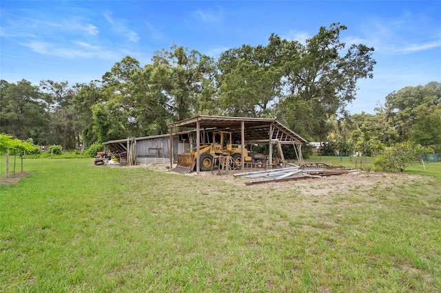 1056 Reynolds Rd, De Leon Springs, FL 32130 - view of green lawn featuring a pole building, view of scattered trees, and an outdoor structure