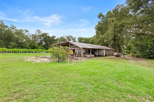 1056 Reynolds Rd, De Leon Springs, FL 32130 - view of grassy yard with an outdoor structure and view of wooded area