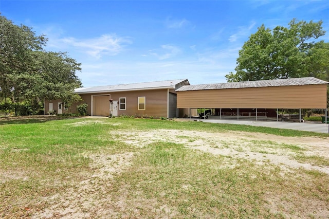 1056 Reynolds Rd, De Leon Springs, FL 32130 - rear view of property featuring metal roof and a yard