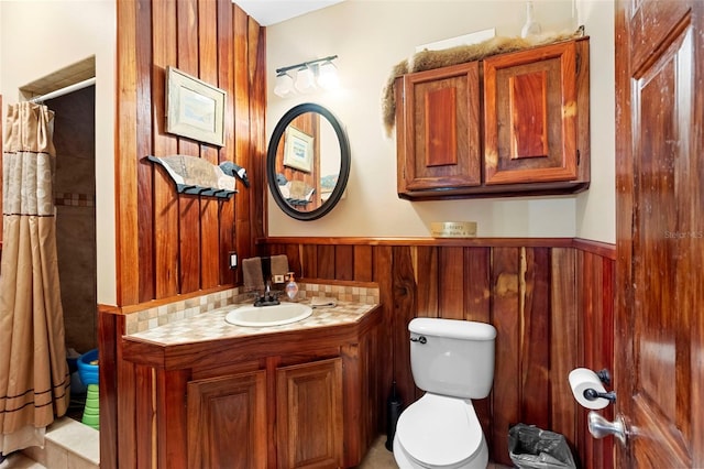 1056 Reynolds Rd, De Leon Springs, FL 32130 - bathroom with toilet, vanity, wainscoting, curtained shower, and wood walls