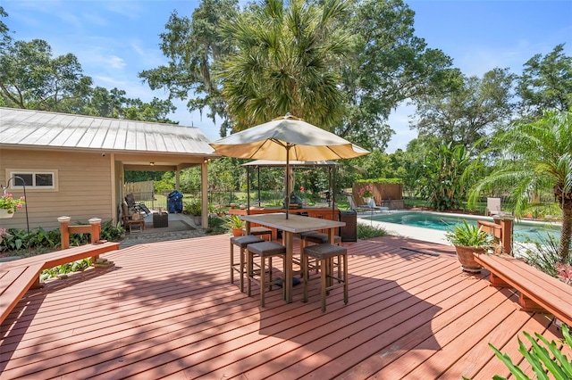 1056 Reynolds Rd, De Leon Springs, FL 32130 - wooden deck featuring an outdoor pool and outdoor dining space