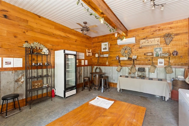 1056 Reynolds Rd, De Leon Springs, FL 32130 - living room featuring a wall mounted AC, beamed ceiling, ceiling fan, wooden walls, and concrete floors