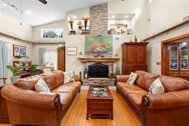 1056 Reynolds Rd, De Leon Springs, FL 32130 - living area featuring high vaulted ceiling, light wood-type flooring, a fireplace, and a ceiling fan