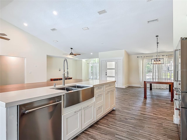 1520 Stone Trl, Enterprise, FL 32725 - kitchen with stainless steel dishwasher, ceiling fan, a sink, light countertops, and lofted ceiling