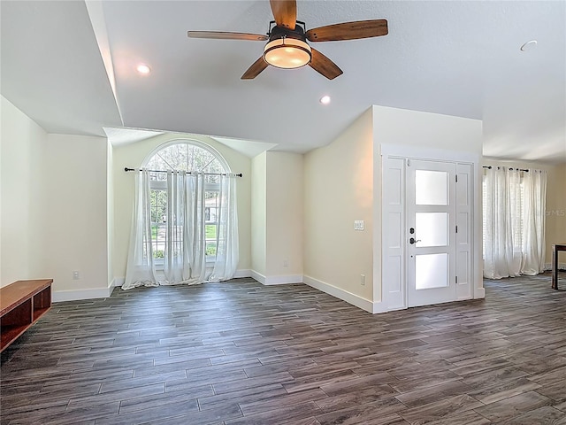 1520 Stone Trl, Enterprise, FL 32725 - unfurnished living room featuring dark wood-type flooring, baseboards, a ceiling fan, vaulted ceiling, and recessed lighting
