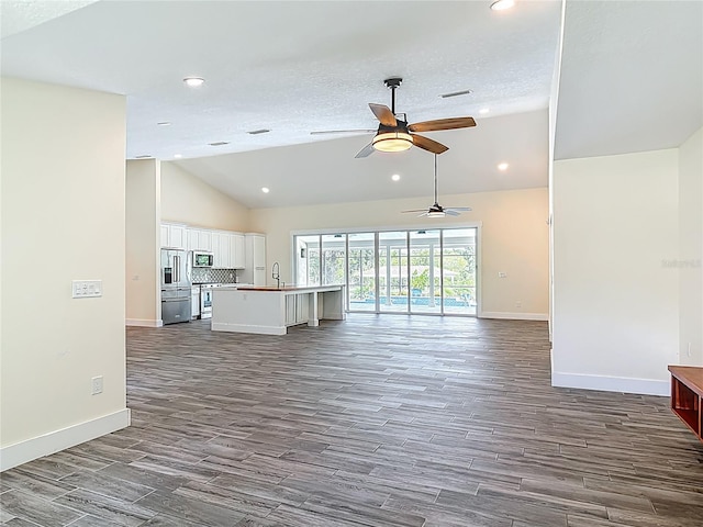 1520 Stone Trl, Enterprise, FL 32725 - unfurnished living room with lofted ceiling, dark wood finished floors, baseboards, recessed lighting, and a ceiling fan