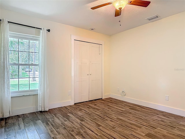 1520 Stone Trl, Enterprise, FL 32725 - unfurnished bedroom with dark wood-style floors, multiple windows, and baseboards