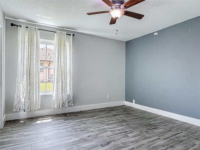 1520 Stone Trl, Enterprise, FL 32725 - empty room with wood finished floors, a textured ceiling, healthy amount of natural light, and a ceiling fan