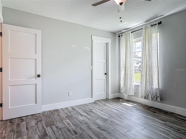 1520 Stone Trl, Enterprise, FL 32725 - empty room featuring wood finished floors, ceiling fan, baseboards, and a textured ceiling
