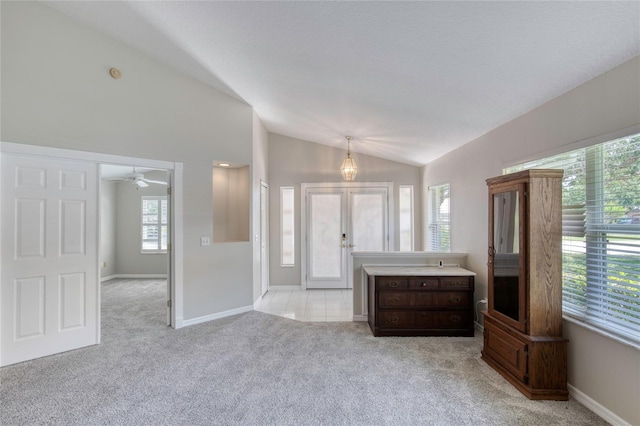 438 Harbour Town Ln, Ormond Beach, FL 32174 - unfurnished living room with vaulted ceiling, light carpet, ceiling fan, baseboards, and french doors