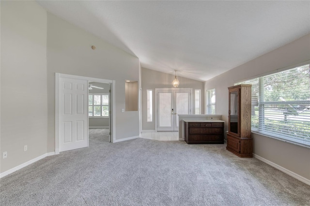 438 Harbour Town Ln, Ormond Beach, FL 32174 - unfurnished living room featuring lofted ceiling, light carpet, and baseboards
