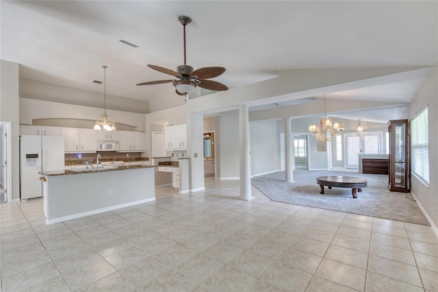 438 Harbour Town Ln, Ormond Beach, FL 32174 - kitchen with white appliances, a chandelier, open floor plan, lofted ceiling, and a center island with sink