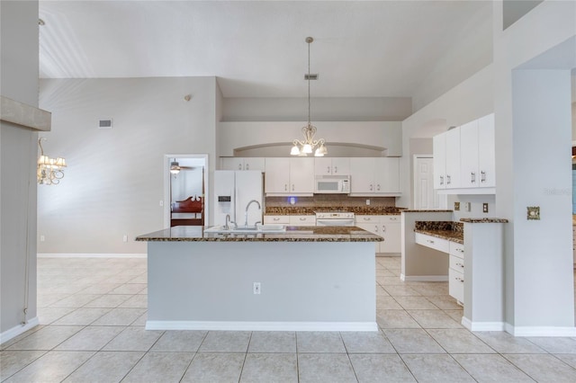 438 Harbour Town Ln, Ormond Beach, FL 32174 - kitchen with white appliances, a chandelier, light tile patterned floors, a sink, and white cabinetry