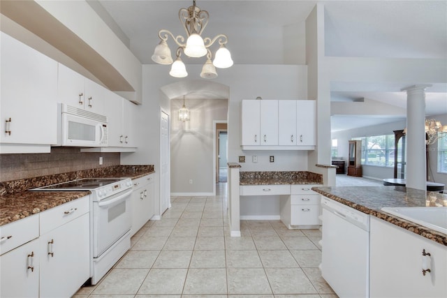 438 Harbour Town Ln, Ormond Beach, FL 32174 - kitchen with white appliances, a chandelier, tasteful backsplash, white cabinetry, and light tile patterned floors
