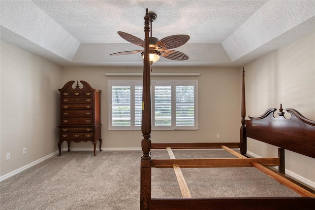 438 Harbour Town Ln, Ormond Beach, FL 32174 - carpeted bedroom featuring a tray ceiling, a textured ceiling, vaulted ceiling, ceiling fan, and baseboards