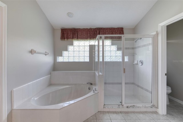 438 Harbour Town Ln, Ormond Beach, FL 32174 - full bathroom with toilet, a garden tub, a stall shower, and tile patterned flooring