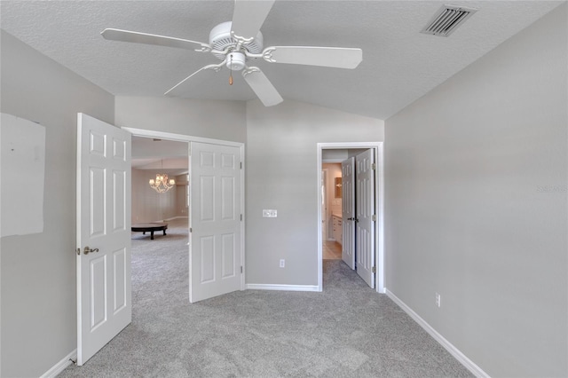 438 Harbour Town Ln, Ormond Beach, FL 32174 - unfurnished bedroom featuring vaulted ceiling, carpet, a textured ceiling, a chandelier, and baseboards