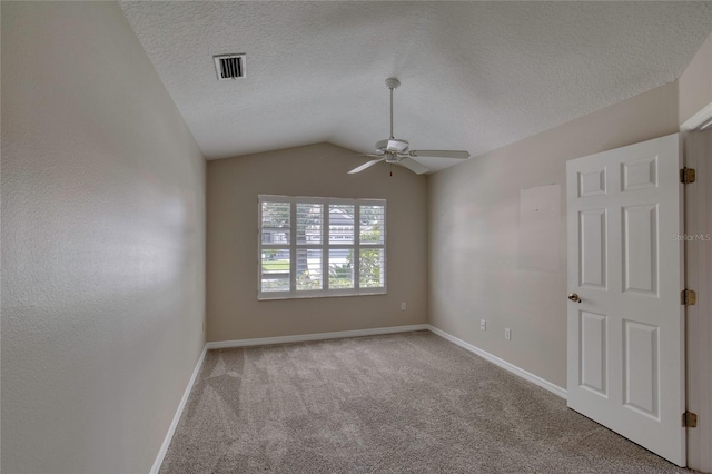 438 Harbour Town Ln, Ormond Beach, FL 32174 - carpeted spare room featuring a ceiling fan, baseboards, vaulted ceiling, and a textured ceiling