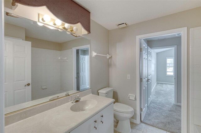 438 Harbour Town Ln, Ormond Beach, FL 32174 - bathroom featuring toilet, vanity, tile patterned floors, and baseboards
