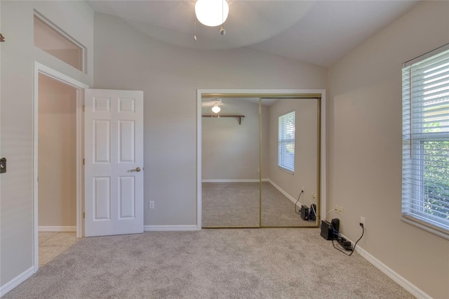 438 Harbour Town Ln, Ormond Beach, FL 32174 - unfurnished bedroom with lofted ceiling, carpet flooring, a closet, baseboards, and ceiling fan