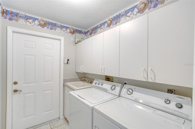 438 Harbour Town Ln, Ormond Beach, FL 32174 - laundry area with separate washer and dryer, cabinet space, a textured ceiling, and light tile patterned floors